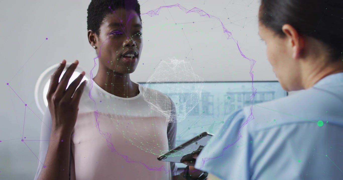 woman raising activating holographic globe in tech meeting with peer tilting tablet aligning nodes