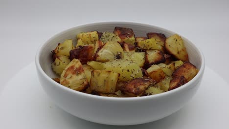 Delicious-roasted-potatoes-with-rosemary-on-turntable