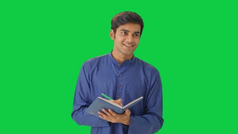 Happy-Indian-man-thinking-and-writing-Green-screen