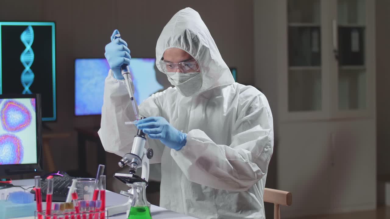 Asian Doctor In Protective Suit Is Doing A Science Experiments And Developing Vaccine In A Modern Lab. Laboratory Assistant Workplace. The Concept Of Science And Medicine