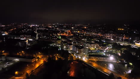 aerial tilting in front of the illuminated skyline of turku city, night in finland