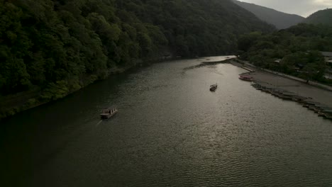 Aerial-Drone-Shot-of-Kyoto-at-Sunset-near-a-river,-Japan,-Asia