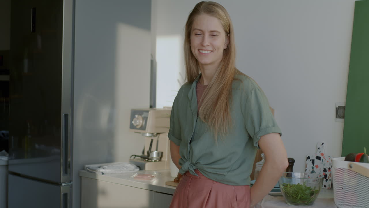 Woman Smiling in a Modern Kitchen