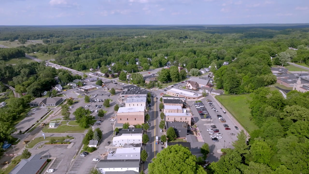 Newaygo, Michigan downtown with drone video moving down.