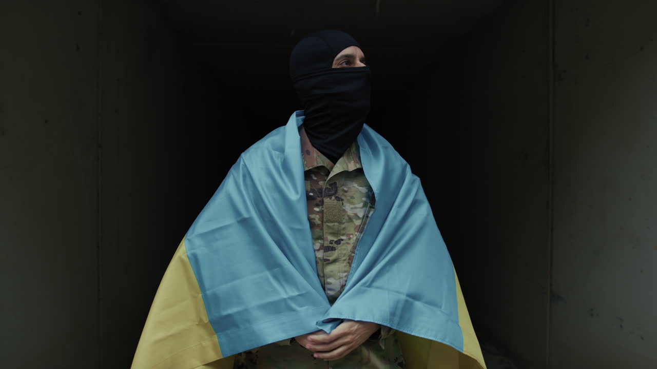 Ukrainian Soldier With Flag Inside a Bomb Defensive Bunker