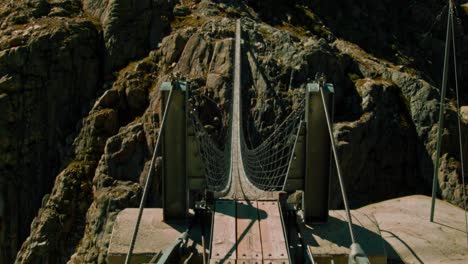 a long bridge between two mountains in bright sunlight