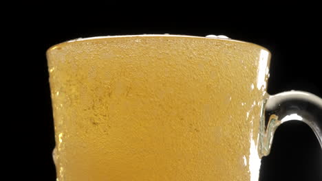 Pouring-blonde-beer-on-pint-glass,-bobbles-and-foam