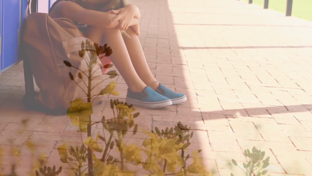 悲しい白人の学童の上に花と草のアニメーション