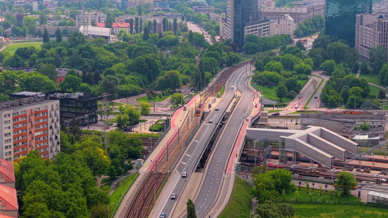 Drone follows tram along Adama Mickiewicza street near Gdanski train station in Zoliborz, Warsaw, establishing tilt up