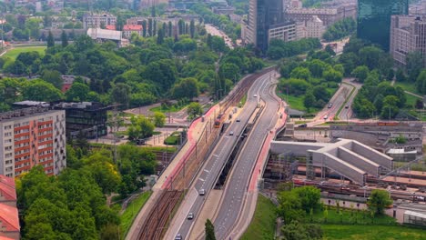 drone follows tram along adama mickiewicza street near gdanski train station in zoliborz, warsaw, establishing tilt up