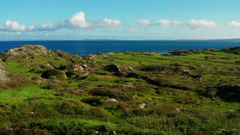 aerial drone footage of connemara's lush greenery, the atlantic ocean, and the burren, descending to a house entrance in galway, ireland