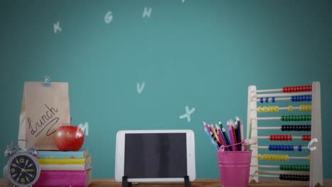 digital composition of multiple alphabets falling over school stationary items on wooden table