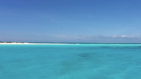 pov sailing on caribbean sea water to white island, los roques, texture water