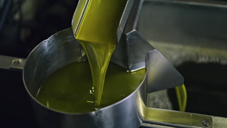 olive oil production process at manufactory vertical close up. liquid flowing