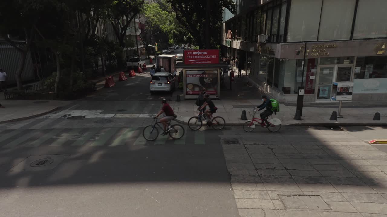 Cyclists and Pedestrians on a Busy City Street in Mexico City