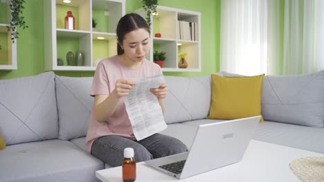 young asian woman reading prospectus, wanting to learn about medical pill.