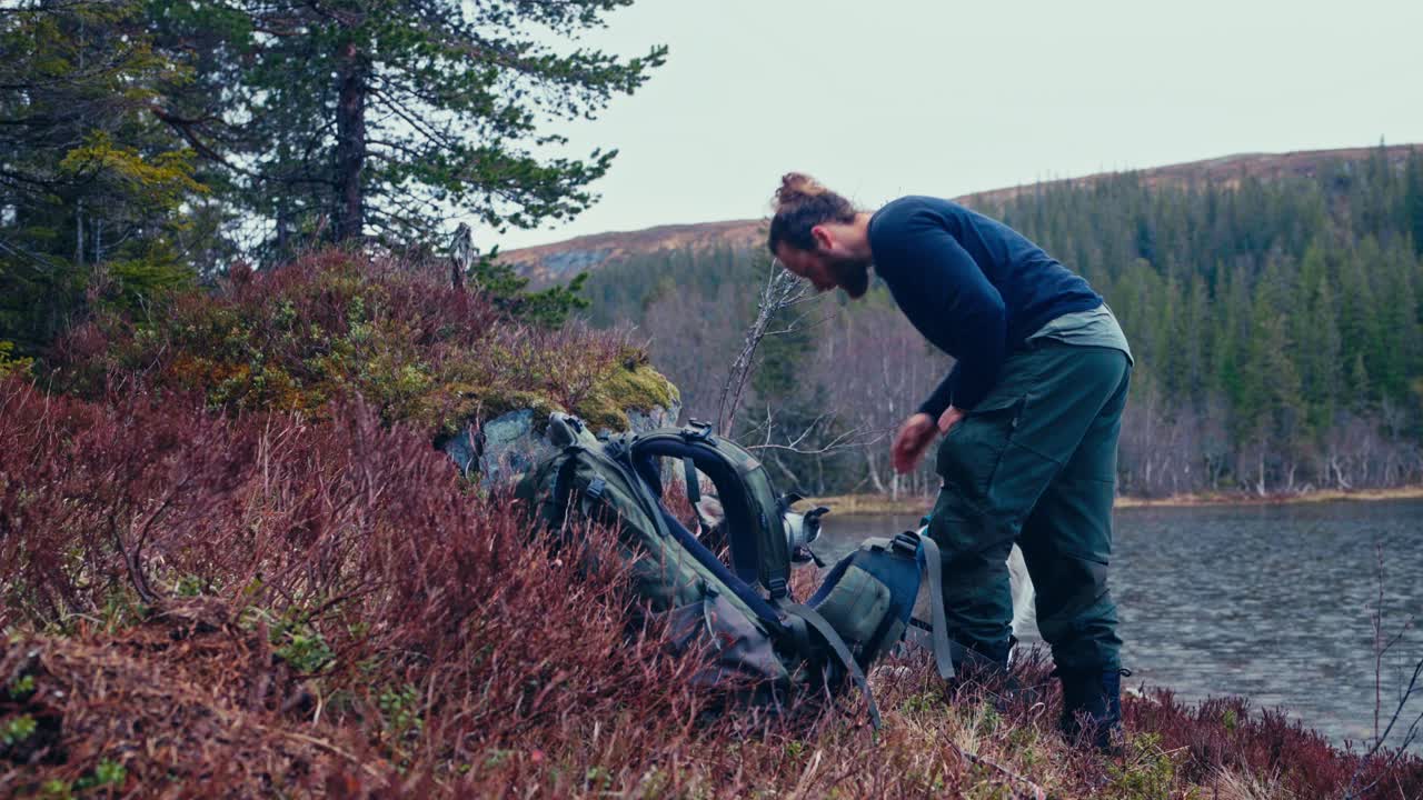 Male Backpacker With Alaskan Malamute Dogs Hiking In Åfjord, Norway - Static Shot