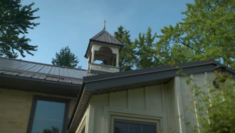 reveal bell tower on top of an old schoolhouse building