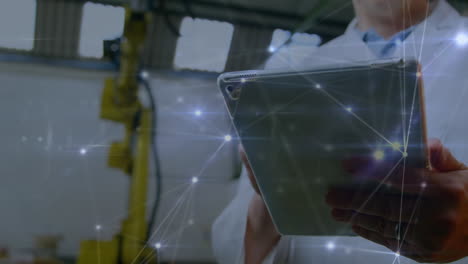 Animation-of-hands-of-caucasian-man-using-tablet-in-computer-laboratory