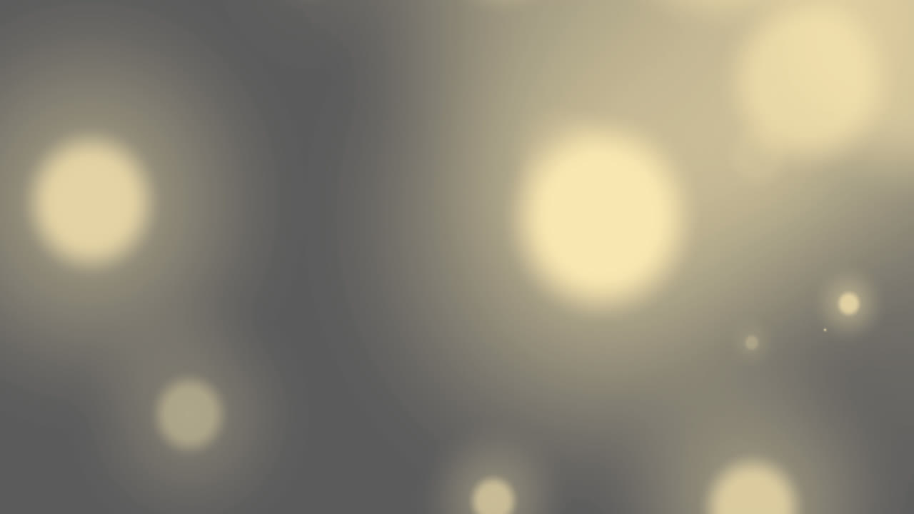 Animation of glowing spots of light moving and flickering in hypnotic motion on out of focus backgro