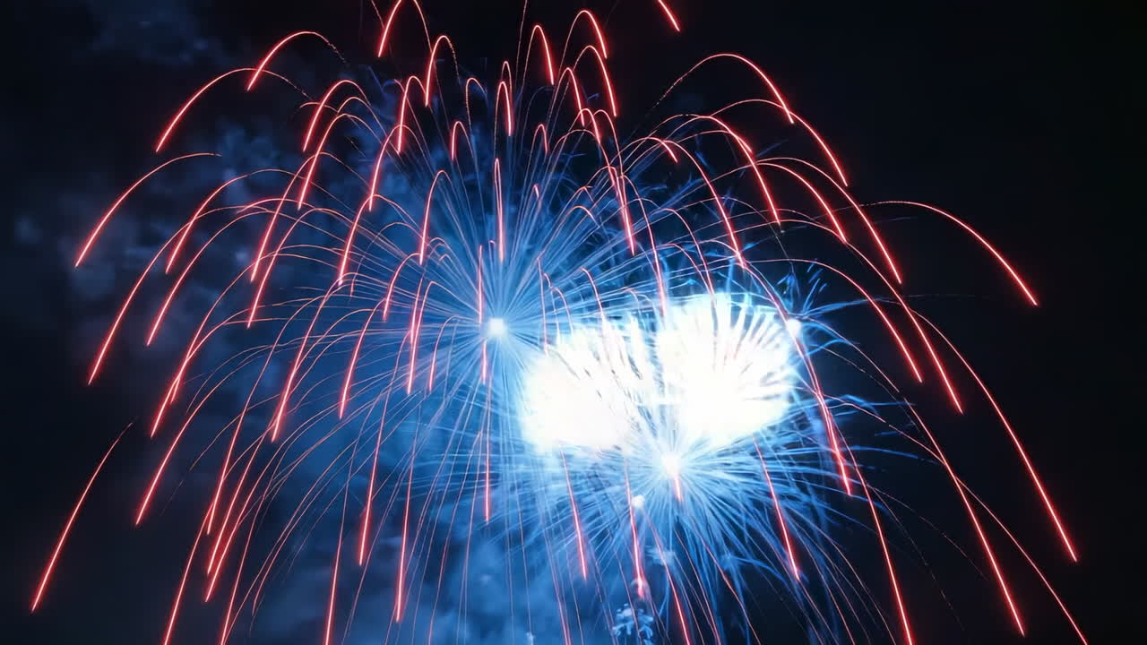 Spectacular Blue and White Fireworks Exploding in the Night Sky