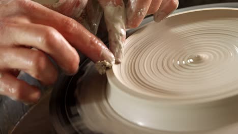 male potter making pot