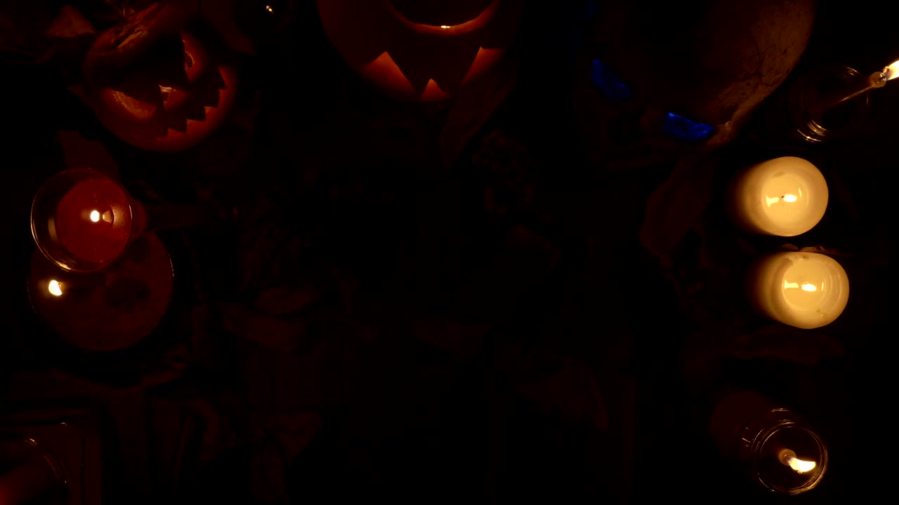 Halloween decorations top view of skull and Jack's pumpkin lanterns, loop video