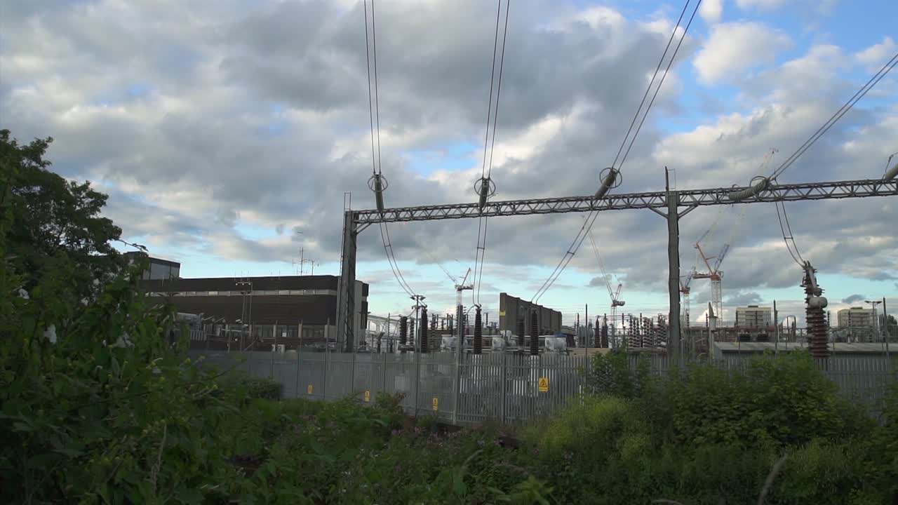 Pan right on a power station with power lines and electricity cables