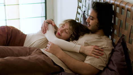 Couple-laying-on-bed