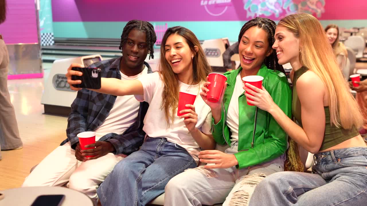 Friends Taking Selfie in Bowling Alley with Red Cups