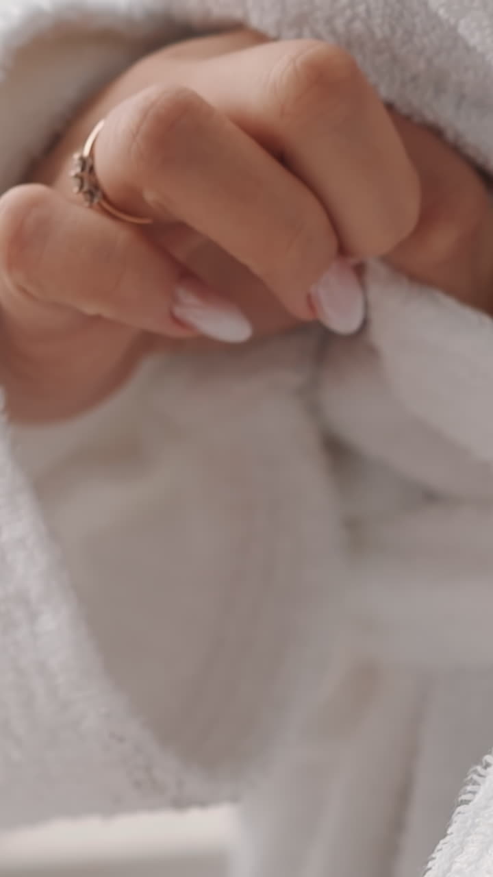 Woman ties belt of white soft bathrobe spending time at spa resort extreme close view. Newlywed bride in luxury hotel. Wellness and wellbeing