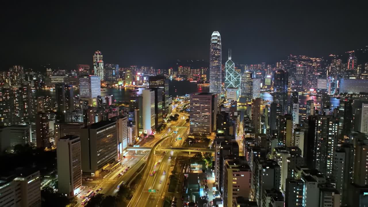 Urban landscape comes alive after sunset with skyscrapers shining bright against the night sky. Busy highways and the river reflect the city’s energy and vitality.