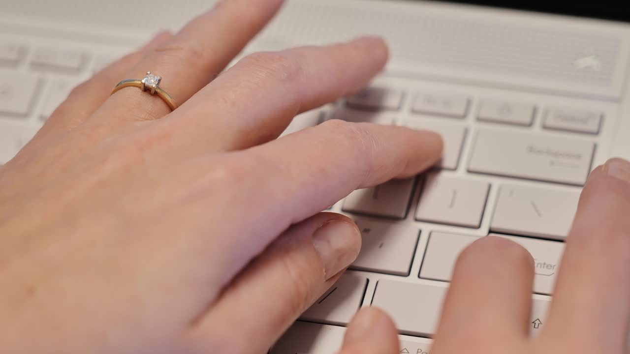 Elegant female fingers with diamond ring typing, blending technology and style