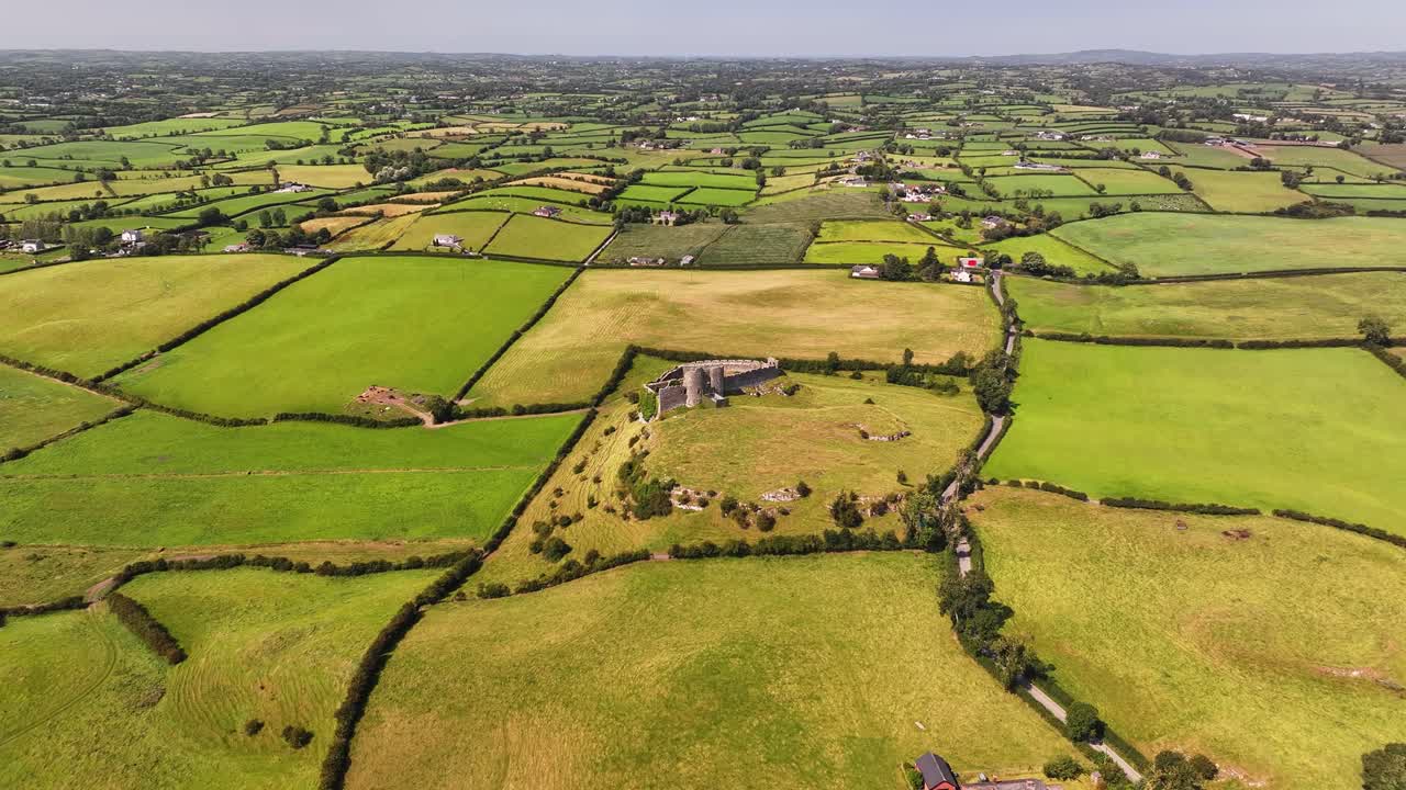 Evergreen pastures in Ireland, beautiful sunny day. Castle Roche. Aerial wide panorama