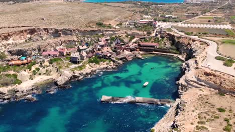 fishing village aerial drone fly backward pan shot