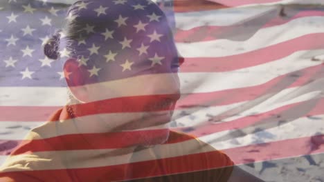 animación de la bandera de los estados unidos de américa sobre el hombre mayor en la playa