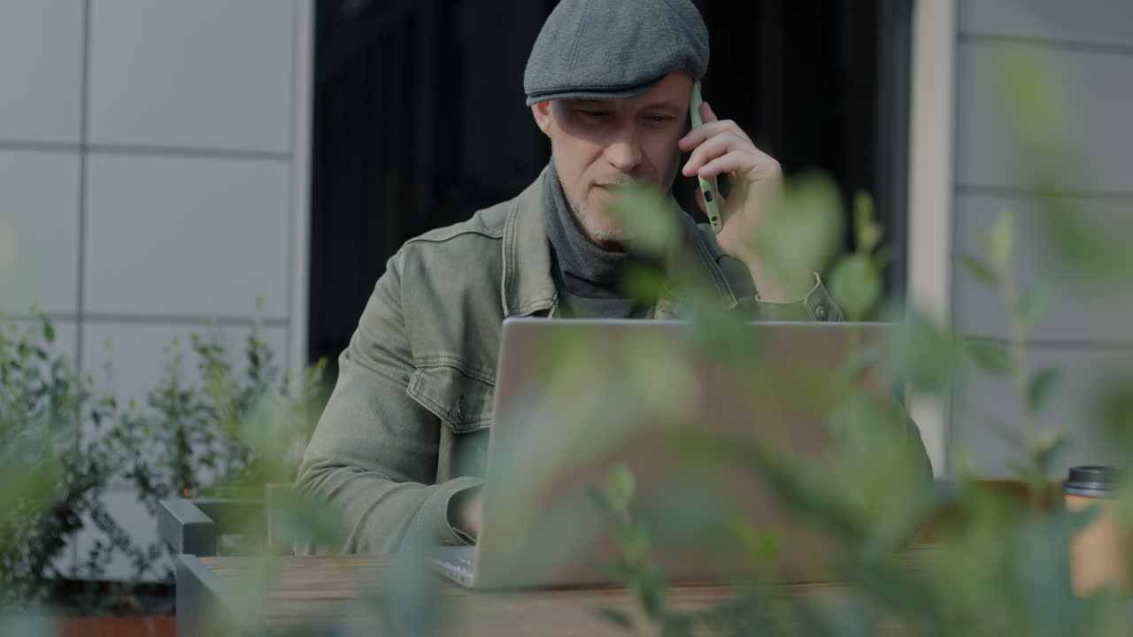 Man working outdoors in a cafe