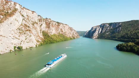 Summer-aerial-drone-shot-of-Danube-Gorge-in-Serbia,-with-impressive-rock-formation-and-a-river-valley