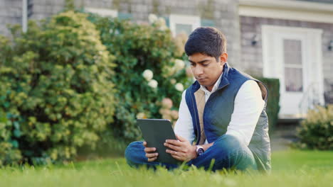 Man-Uses-Tablet-in-Backyard