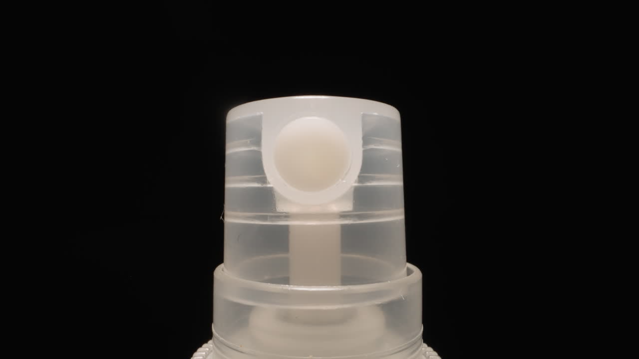 Sprinkler of mouth freshener with hole on black background