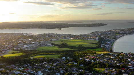 aerial view of a coastal city and bay at sunrise or sunset