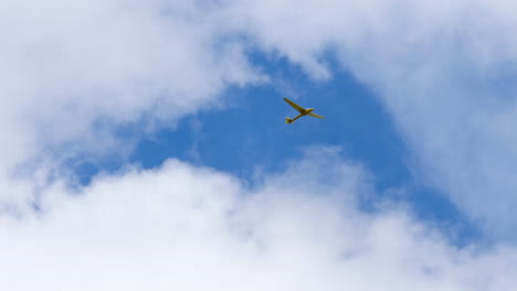 Sailplane-Glider-Flying-in-the-Sky,-Low-Angle-White-Cloud-Backdrop