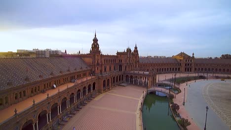 Drone-shot-of-Plaza-de-España-in-Seville,-sunrise,-summer,-sun