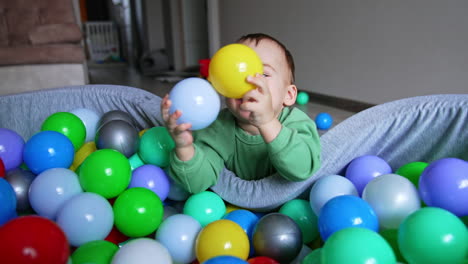 baby playing in a ball pit
