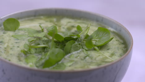 watercress recipe. soup rotating in bowl with white background. healthy lunchtime food.protein plant based raw vegan food. health and vegetarian foods. healthy ingredients. 4k macro food shot
