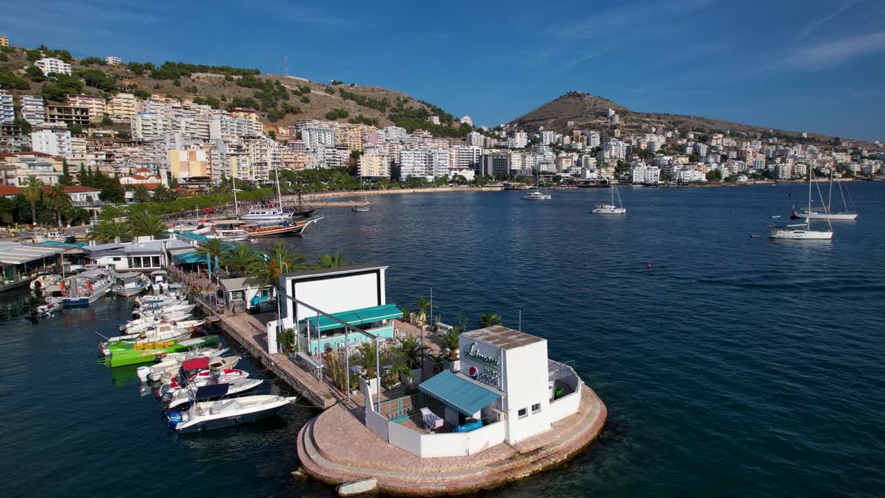 Saranda's Tranquil Pier: Anchored Tour Boats in the Coastal City, Perfect for Sunny Summer Vacation and Memorable Resort Beach Holidays