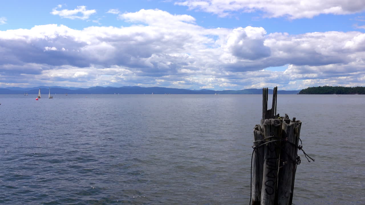 A mooring post in the foreground of Lake Champlain