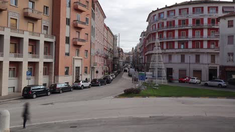 traffic timelapse in a typical italian town - buildings and vehicles passing on the main road