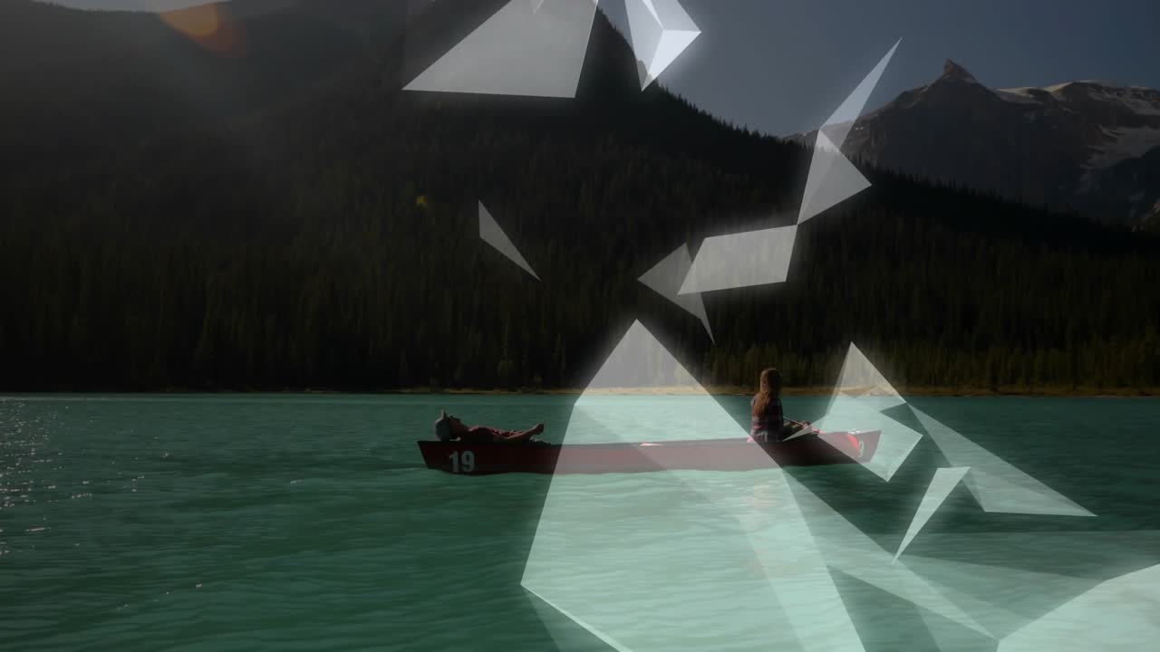 Drifting red canoe with woman in sleeveless top and man relaxing on turquoise lake shards rising