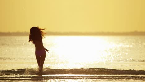 ethnic female in swimwear on tropical ocean beach